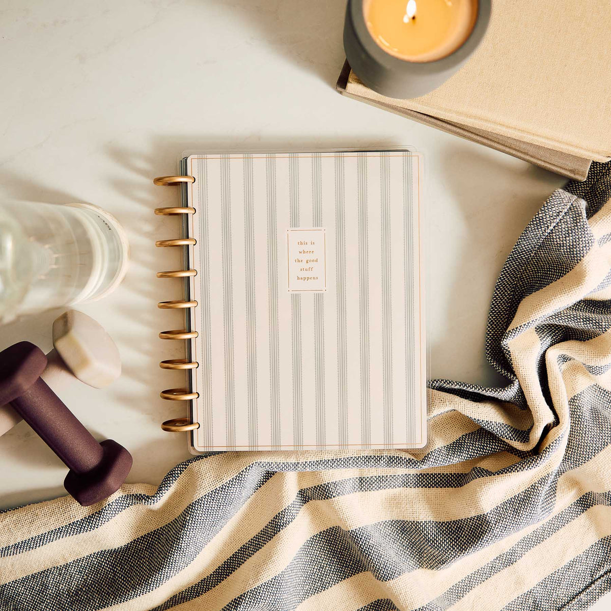 Haven & Heart striped fitness journal beside fitness accessories