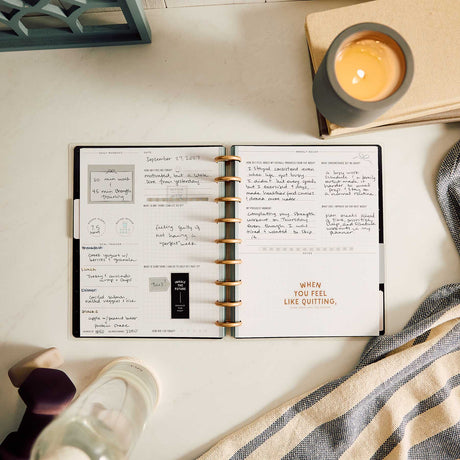 Open Haven & Heart journal with handwritten workout notes beside a coffee cup