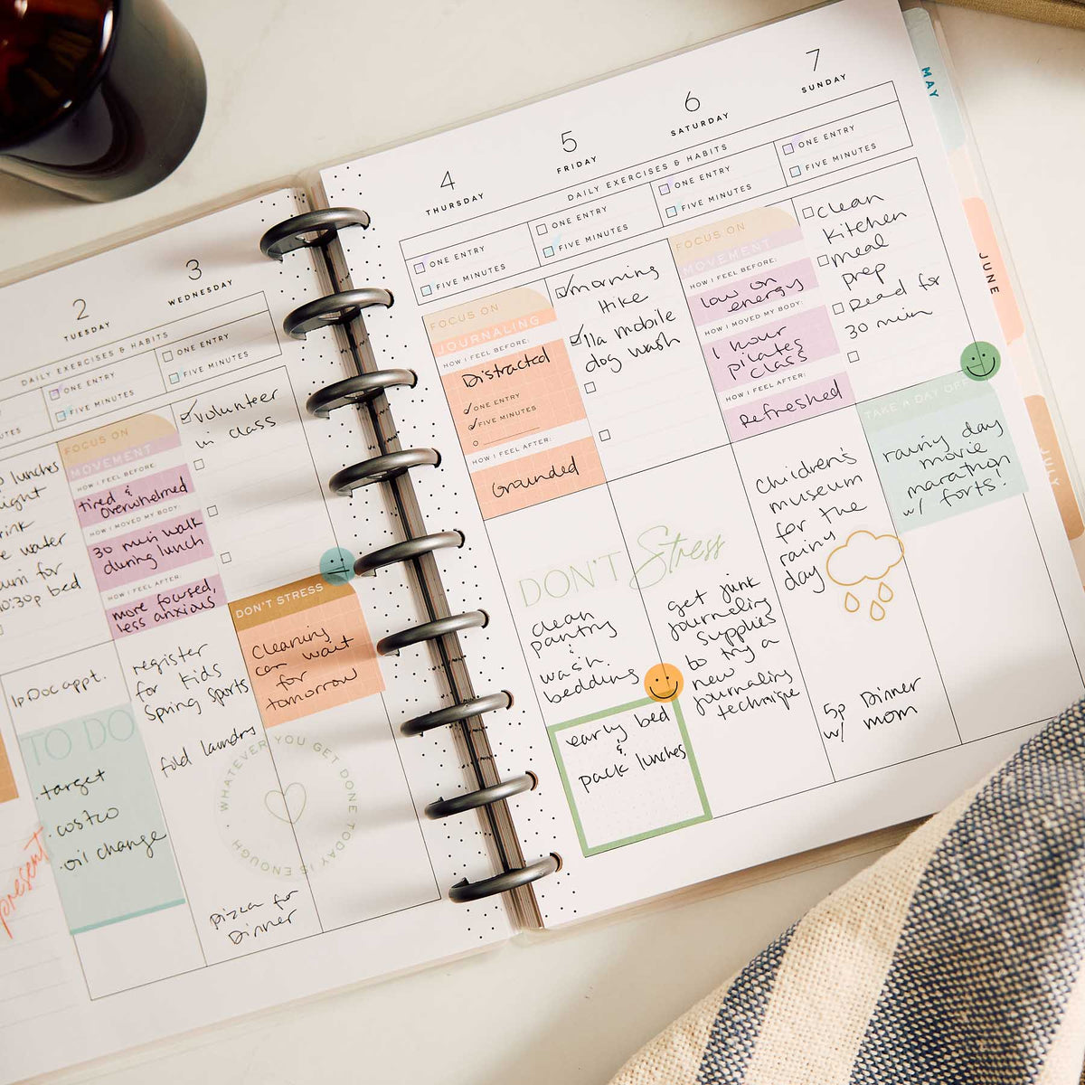 Hushed Hues handwritten weekly spread with pastel sections and disc binding