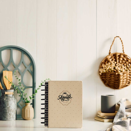 Haven & Heart planner beige cover displayed on a desk beside books