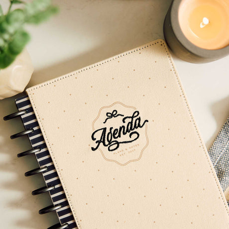 Haven & Heart planner cream Agenda cover and black discs beside a candle