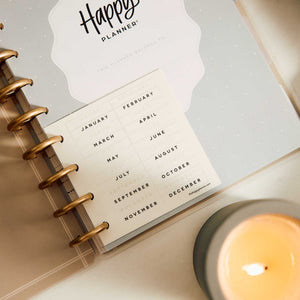 Happy Planner Haven & Heart Classic daily undated planner - calendar insert with gold discs beside a candle