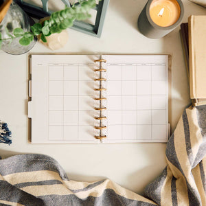 Happy Planner Haven & Heart Classic daily undated planner - blank daily spread beside a candle and blanket