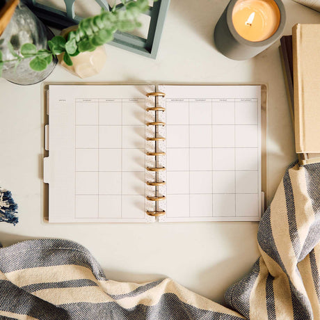 Happy Planner Haven & Heart Classic daily undated planner - blank daily spread beside a candle and blanket