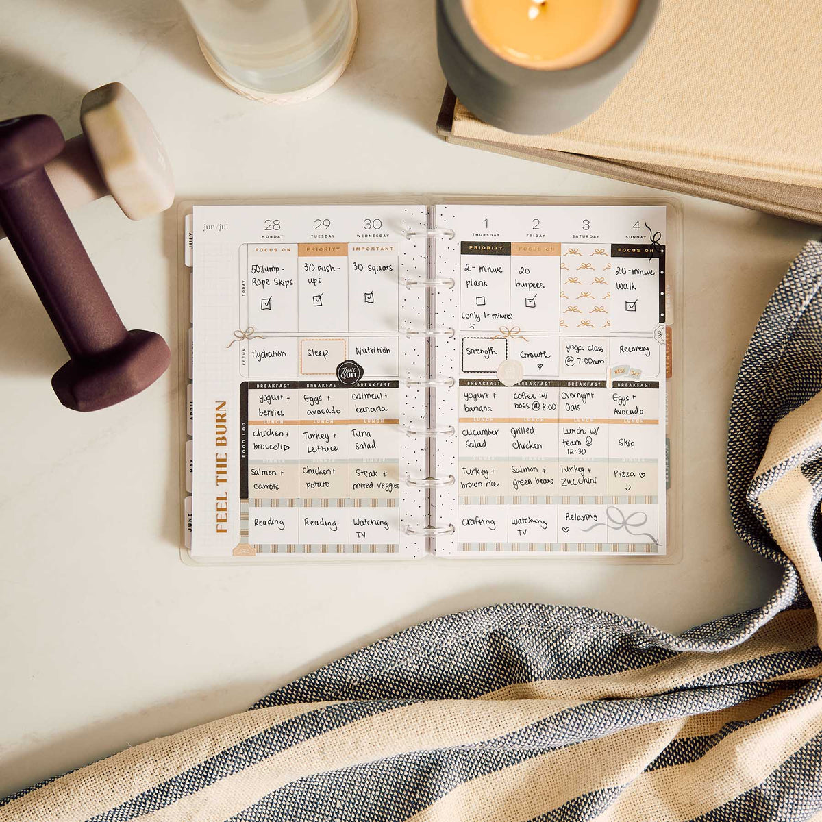 Haven and Heart Mini workout schedule with exercise notes beside dumbbells, candle and towel