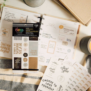 Haven & Heart sticker sheets beside an open planner with decorative and motivational designs