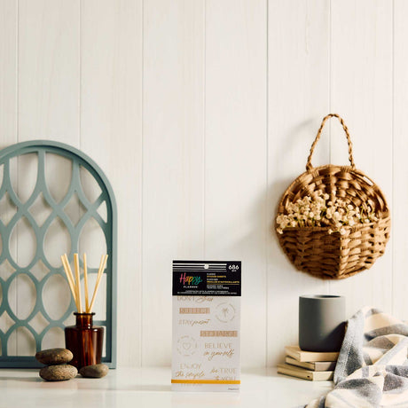 Happy Planner Hushed Hues sticker book displayed beside a mug, diffuser and woven wall basket