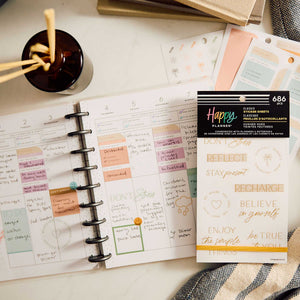 Hushed Hues Stress Management sticker book on a weekly planner spread with pastel reflection labels