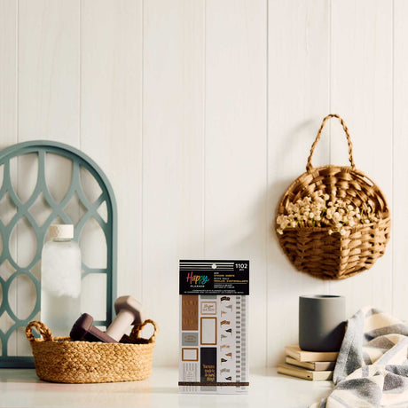 Haven & Heart Fitness sticker book displayed beside a basket of dumbbells and neutral home accessories