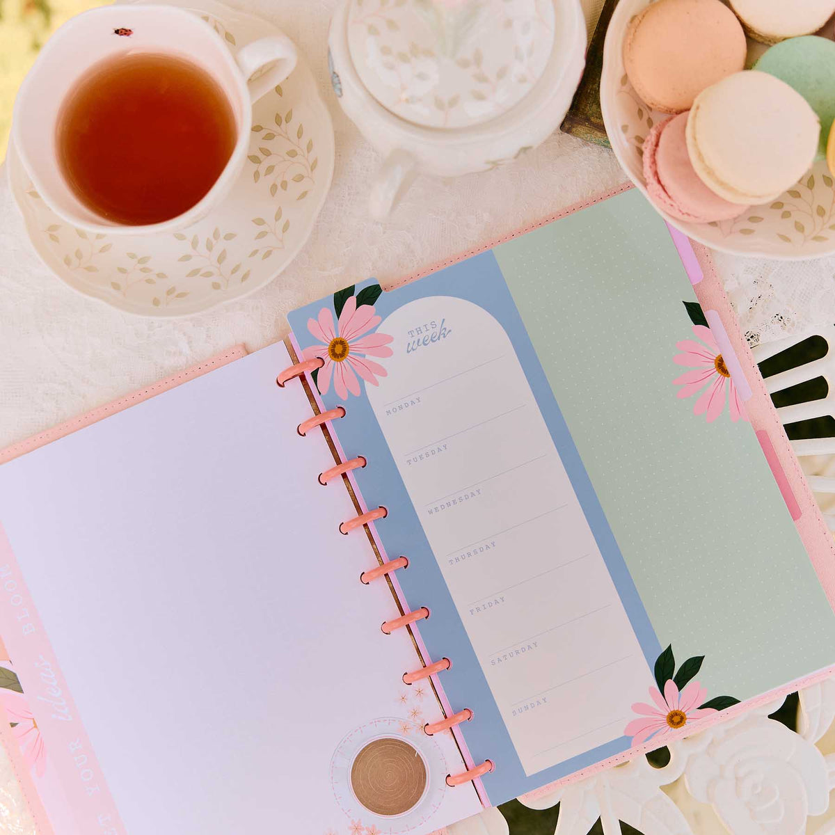 Petal Press daily planning page with pink discs beside tea and macarons