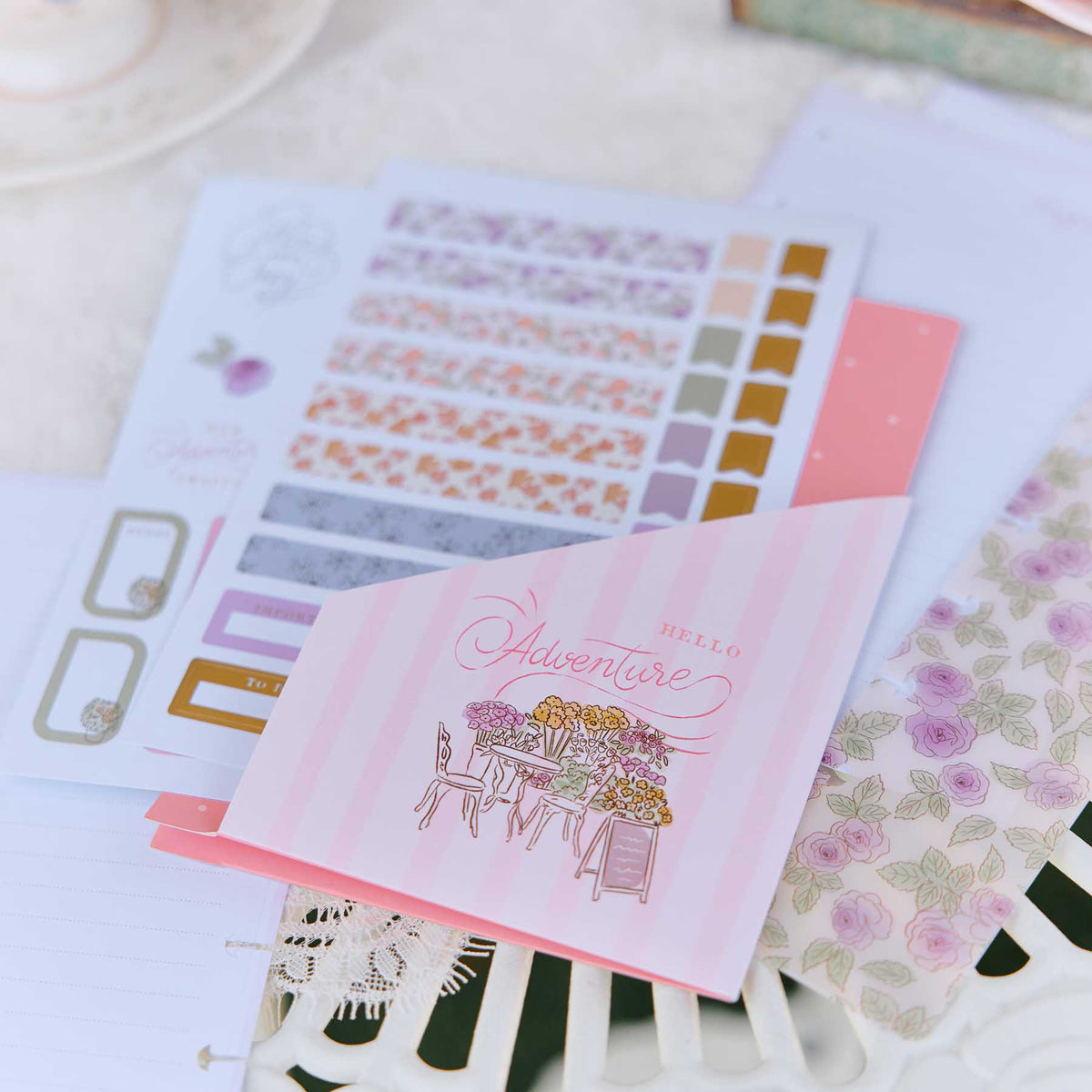 Seasonal Sidewalks pastel stickers and paper with floral patterns and a pink adventure card