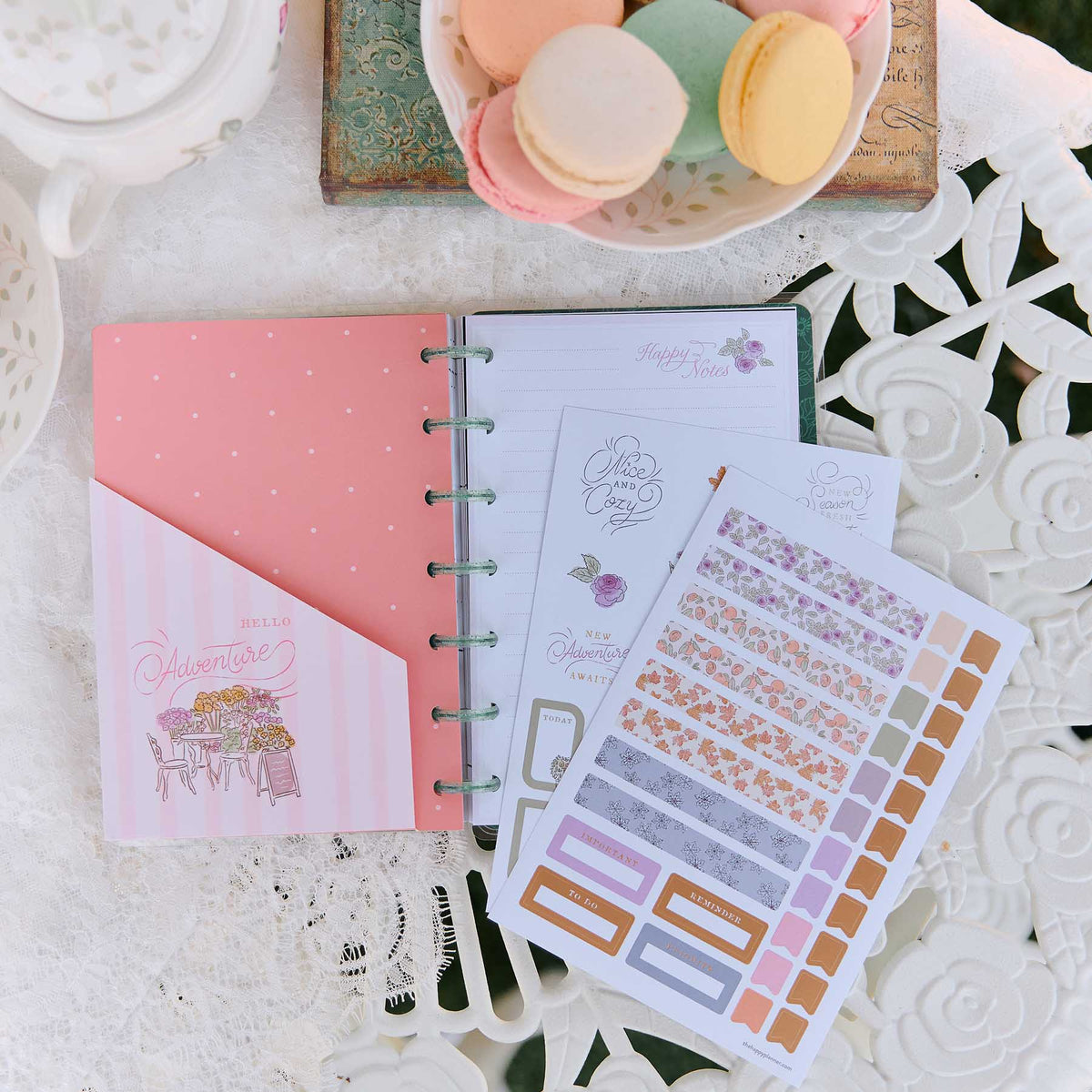 Seasonal Sidewalks pastel stickers beside an open disc-bound planner and floral stationery