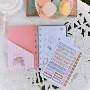 Seasonal Sidewalks pastel stickers beside an open disc-bound planner and floral stationery