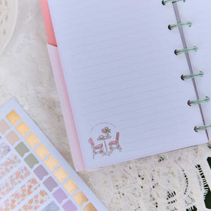 Happy Planner Seasonal Sidewalks stickers beside a lined page with a sidewalk cafe