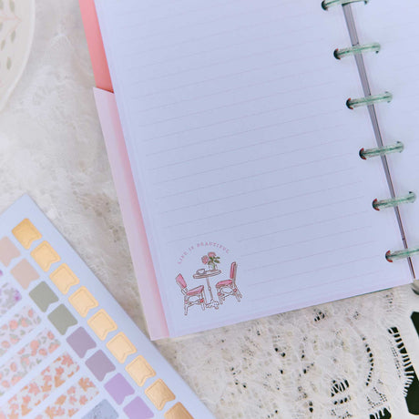 Happy Planner Seasonal Sidewalks stickers beside a lined page with a sidewalk cafe