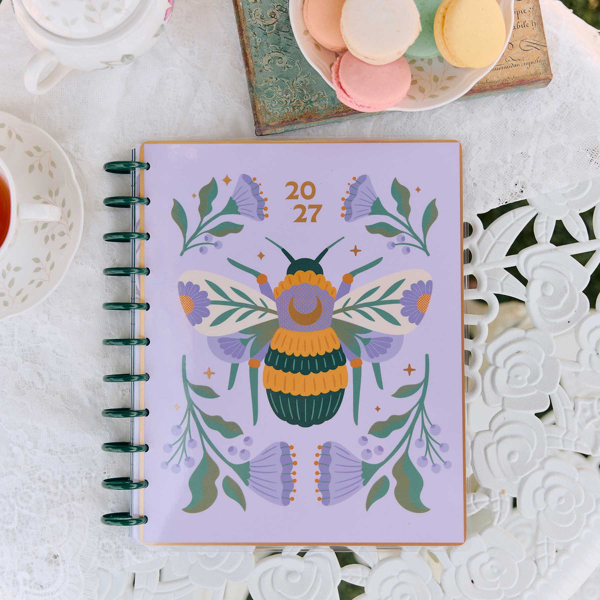 Happy Planner Hive and Bloom lavender floral and bee cover beside tea and macarons
