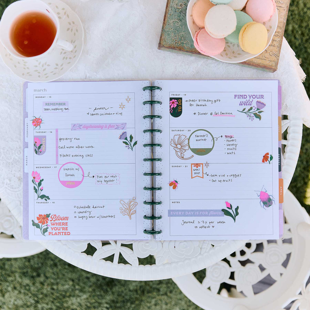 Hive and Bloom planner open spread decorated with floral stickers and planning sections