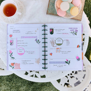 Hive and Bloom planner open spread decorated with floral stickers and planning sections