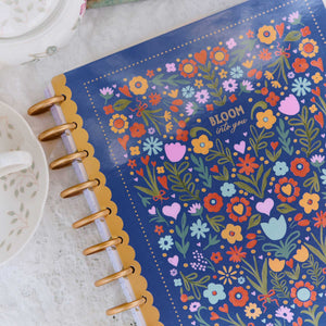 Happy Planner Little Garden blue floral cover and gold discs on a lace table setting