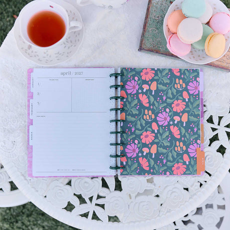 Happy Planner Hive & Bloom Classic Vertical Planner 2027: Monthly spread beside the floral cover