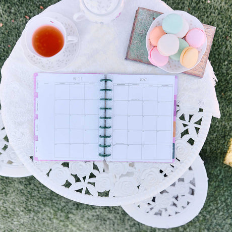 Happy Planner Hive & Bloom Classic Vertical Planner 2027: Monthly spread styled with tea and macarons