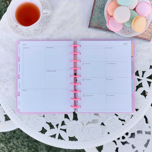 Petal Press planner monthly spread with pink discs on a decorative table
