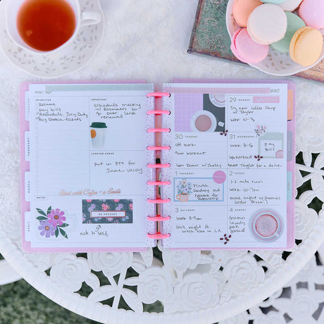 Petal Press planner open with handwritten plans, floral stickers and pastel pages