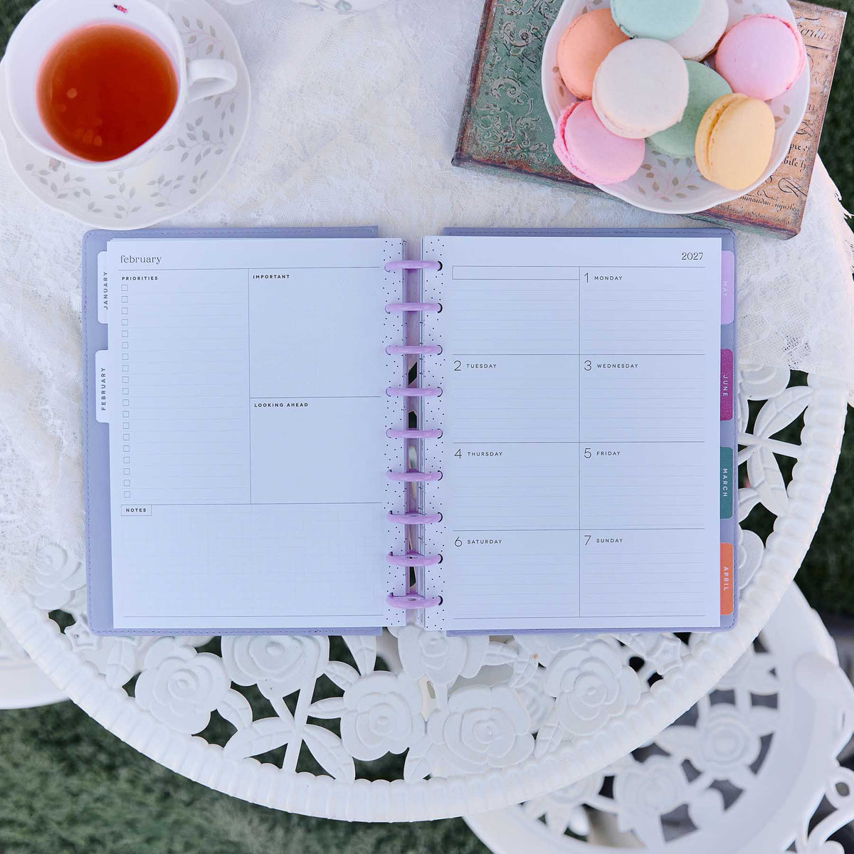 Happy Planner Hive & Bloom Classic Dashboard Planner 2027 - monthly spread beside tea and pastel macarons