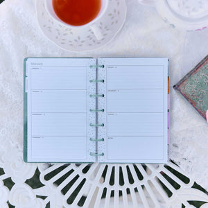 Happy Planner Petal Press lined weekly spread beside tea and a journal
