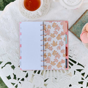 Happy Planner Seasonal Sidewalks grid filler paper and floral leaf dashboard on a lace tablecloth
