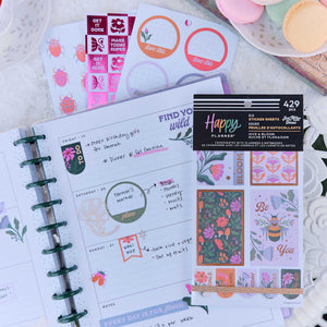 Hive & Bloom Big Sticker Book displayed on an open Happy Planner with floral decorations