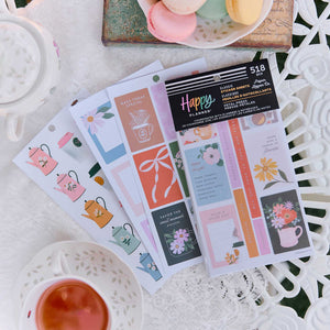 Petal Press pastel floral stickers beside teacups and stationery