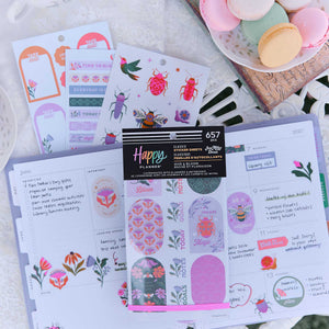 Hive & Bloom sticker book on decorated planner pages with floral labels and garden insect designs