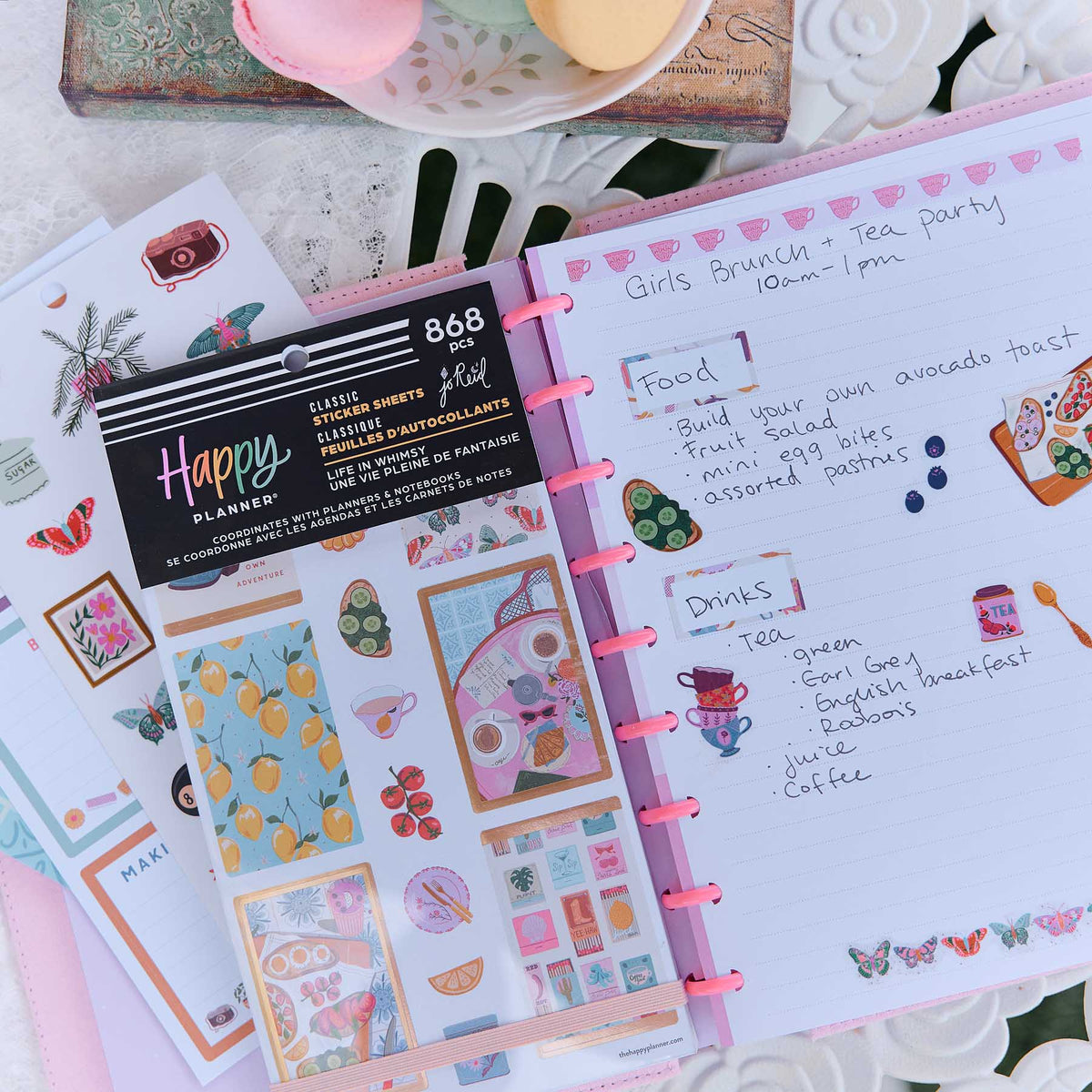Life In Whimsy sticker book on a pink disc planner decorated with butterflies and a tea party checklist
