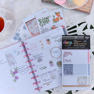 Seasonal Sidewalks sticker sheets beside an open disc-bound planner