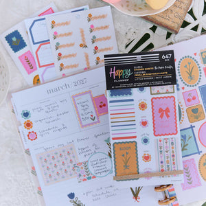 Little Garden sticker book and floral label sheets on an open March planner page