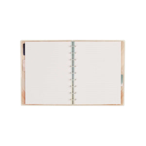 Open Starlit Glow notebook showing dotted-lined pages and disc binding