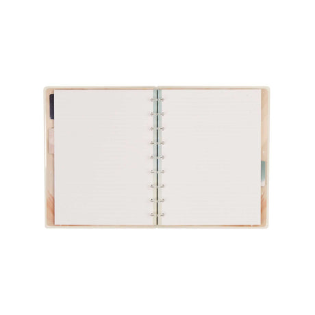 Open Starlit Glow notebook showing dotted-lined pages and disc binding