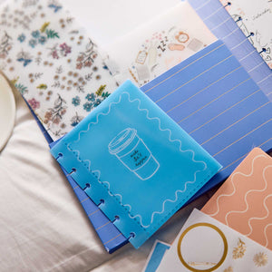 Pajama Plans discbound pages and decorative stickers on a fabric surface