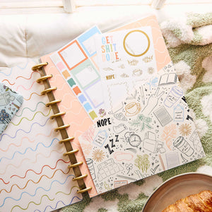 Open discbound planner with Pajama Plans colourful filler paper and a doodle page