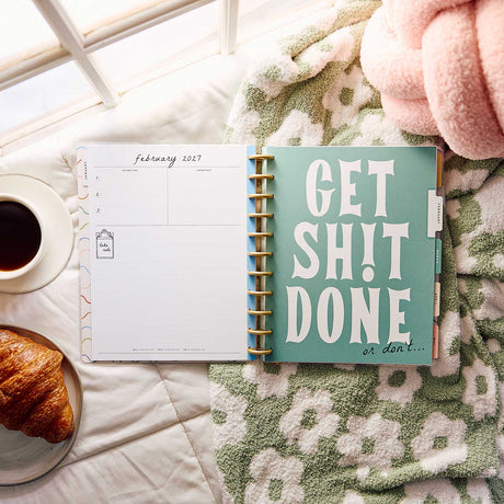 Happy Planner Pajama Plans open to a February 2027 spread and motivational divider