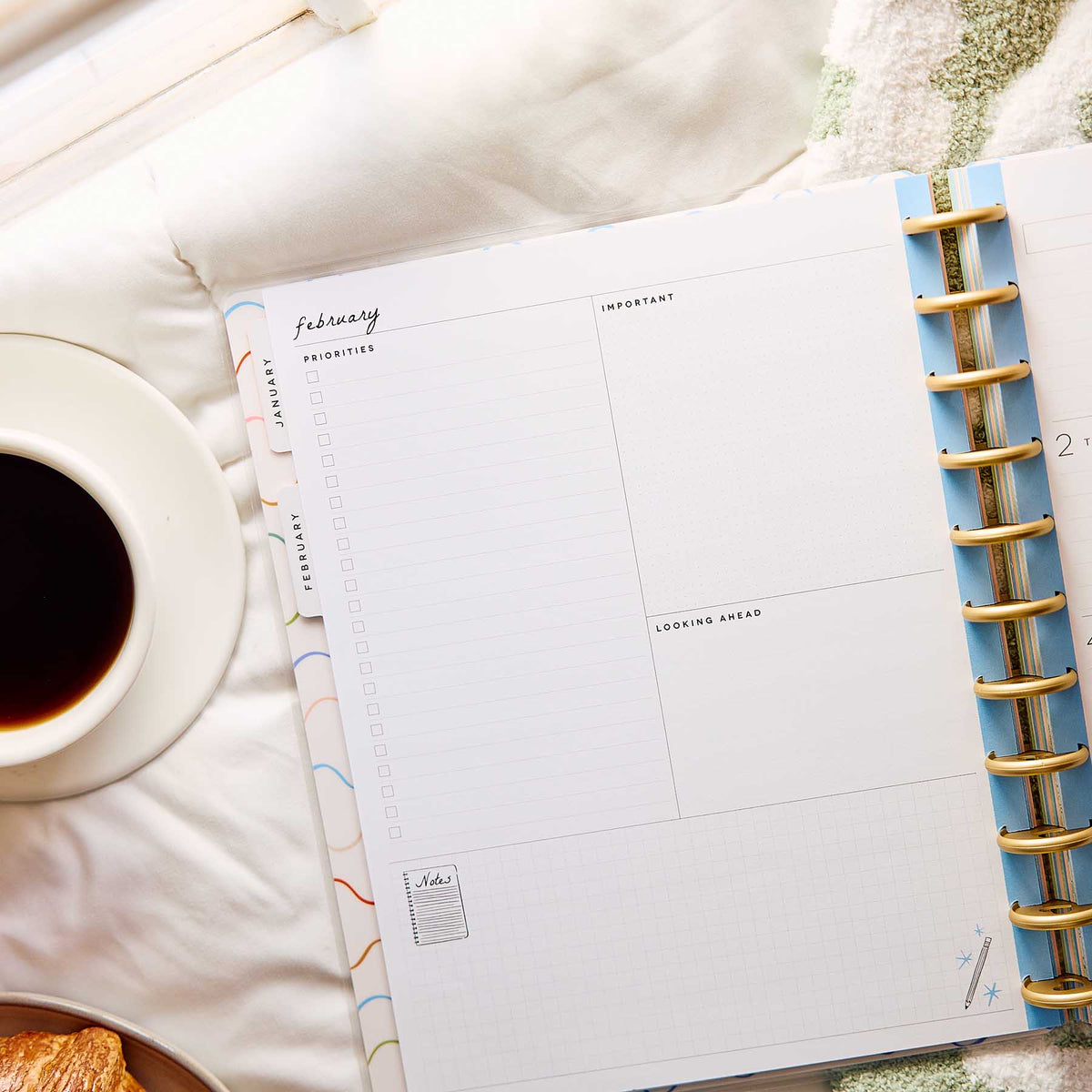 Happy Planner Pajama Plans February dashboard with priority sections beside coffee