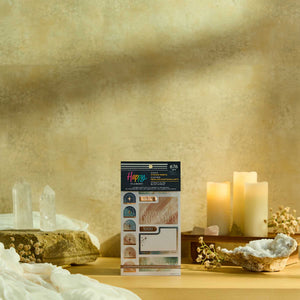 Starlit Glow sticker book displayed beside crystals and candles