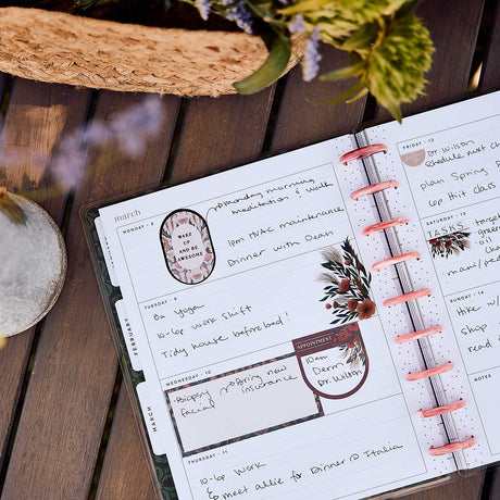 Happy Planner Twilight Tapestry Classic Horizontal Planner 2027: Handwritten notes and pink discs on a wooden table
