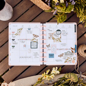 Wildflower Daydream planner decorated floral monthly spread on a wooden table