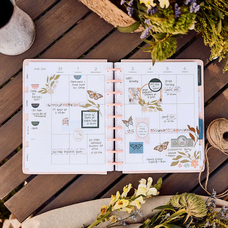 Wildflower Daydream planner decorated floral monthly spread on a wooden table