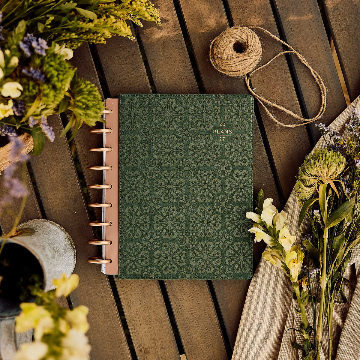 Twilight Tapestry green floral planner on a wooden table beside dried flowers