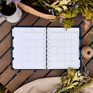 Happy Planner Wildflower Daydream Classic Dashboard Planner 2027 - floral monthly dashboard spread on a wooden table
