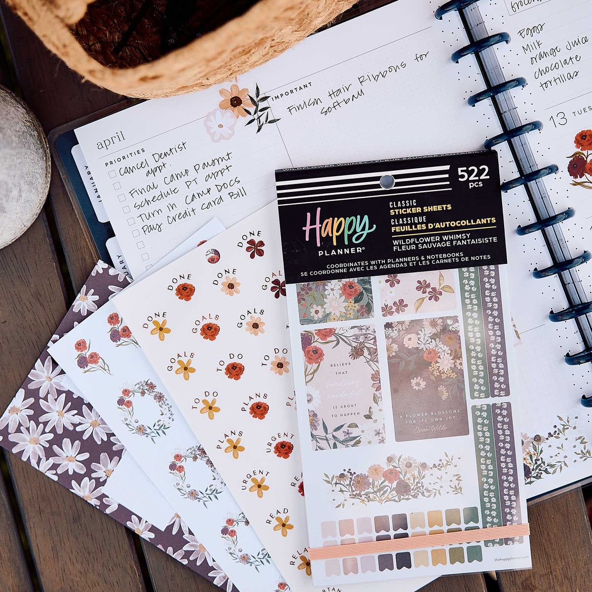 Wildflower Whimsy sticker book on an open weekly planner with floral stickers and handwritten plans