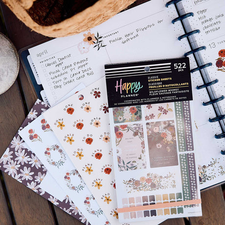 Wildflower Whimsy sticker book on an open weekly planner with floral stickers and handwritten plans